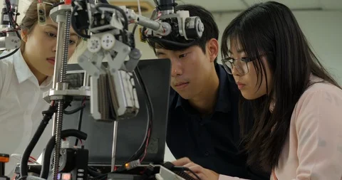 Team of robotics engineer assembling and testing robotics responses with laptop Video stock 94654973