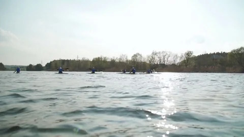 Team of rowing people sailing in sunset Stock Footage 74467375