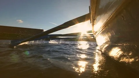 Team rowing a wooden boat in a race Stock Footage