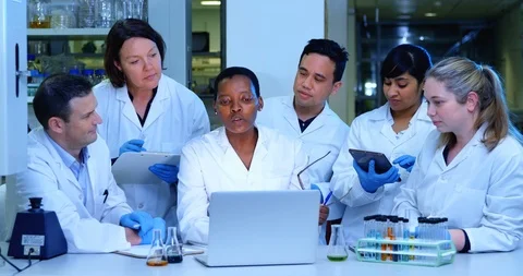 Team of scientist discussing over a laptop 4k Stock Footage 95978046