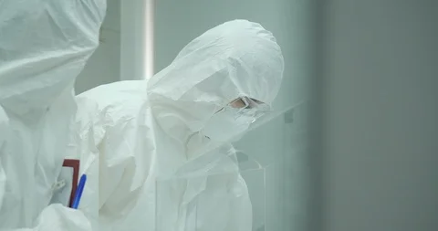 Team of scientist working in a secure high level research laboratory. Stock Footage 93813696