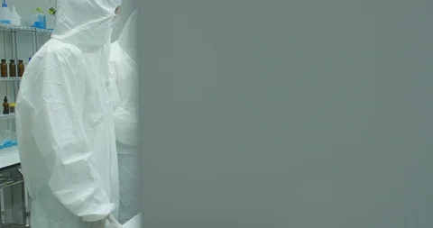 Team of scientist working in a secure high level research laboratory. Stock Footage 93844178