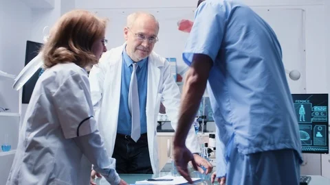 Team of scientists and an assistant are talking Stock Footage 111056940