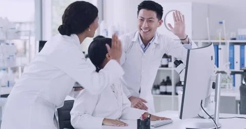 Team of scientists celebrating with high five gesture after genetic breakthrough Stock Footage 200794147