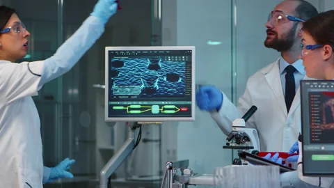 Team of scientists doing biological researches under microscope Stock Footage 144879566