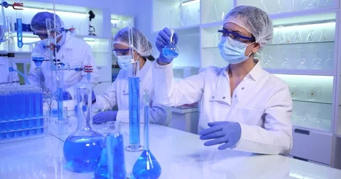 Team of Scientists Group Cooperation and Working Glassware in Dark Laboratory Stock Footage 85484364