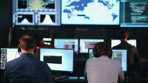 Team of security personnel watching the screens in a system control center. This Stock Footage