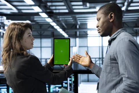 Team of server hub engineers using green screen laptop 写真素材