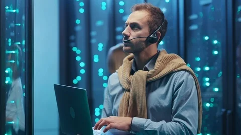 Team of server technicians coworking at high tech digital room. Blackout in data Stock Footage 119976936