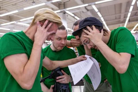 The team is shocked by the script, reading papers. backstage. Stock Photos