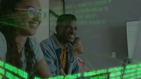 Team sitting at desk facing screen green finance data scrolling typing on tab Stock Footage 333901257