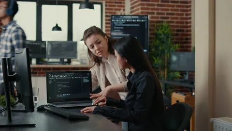 Team of software developers comparing source codes running on laptop screen and 스톡 동영상 168233270