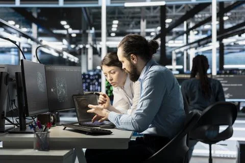 Team of software developers in data center integrate AI driven automation tools Stock Photos