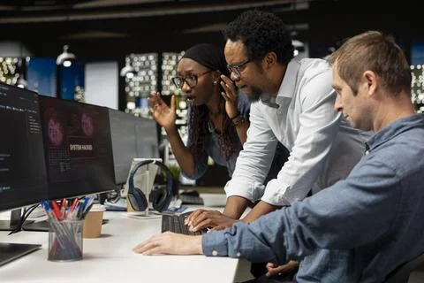 Team of software developers detecting and blocking hacker intrusion 스톡 사진
