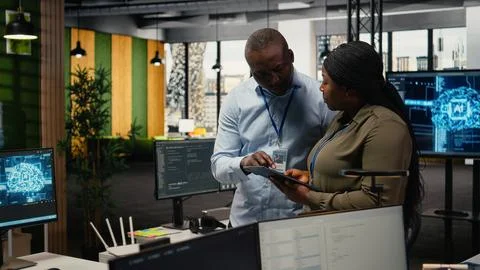 Team of software developers in office automating workflows using AI Stock Photos