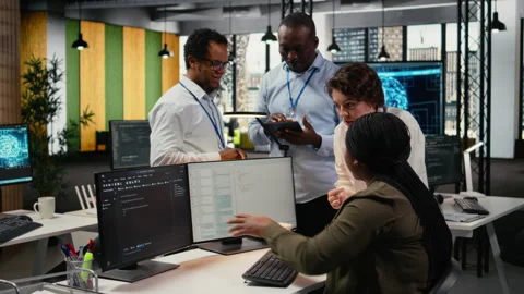 Team of software developers in office working together, automating using AI Stock Footage 323144729