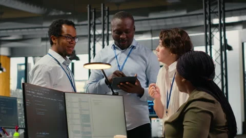 Team of software developers in office working together, automating using AI Stock Footage 323239378