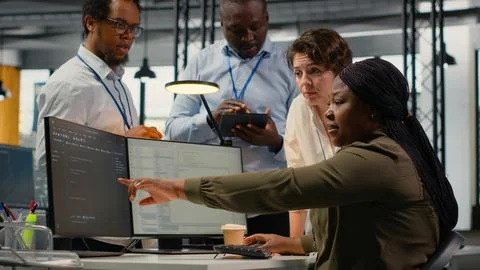 Team of software developers in office working together, automating using AI Stock Photos