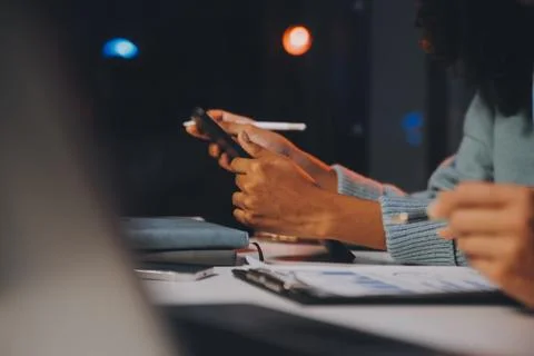 Team of software developers working on big project late at night in neon li.. 库存照片