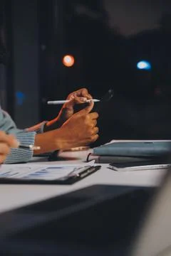 Team of software developers working on big project late at night in neon li.. 库存照片