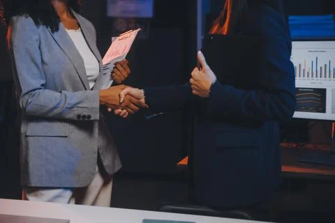 Team of software developers working on big project late at night in neon li.. 库存照片