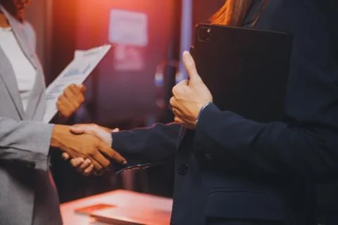 Team of software developers working on big project late at night in neon li.. 库存照片