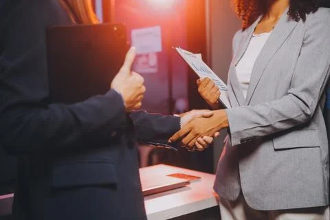 Team of software developers working on big project late at night in neon li.. 库存照片