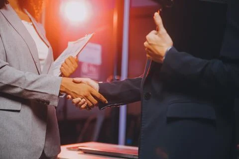 Team of software developers working on big project late at night in neon li.. 库存照片