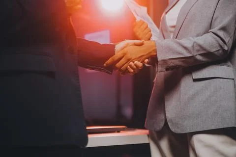 Team of software developers working on big project late at night in neon li.. 库存照片