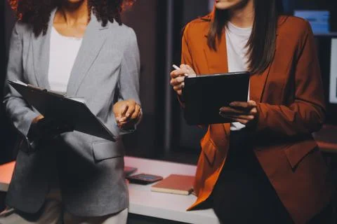 Team of software developers working on big project late at night in neon li.. 库存照片