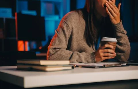 Team of software developers working on big project late at night in neon li.. 库存照片