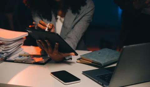 Team of software developers working on big project late at night in neon li.. 库存照片