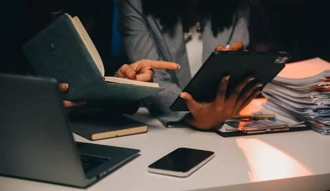 Team of software developers working on big project late at night in neon li.. 库存照片