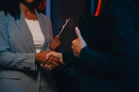 Team of software developers working on big project late at night in neon li.. 库存照片