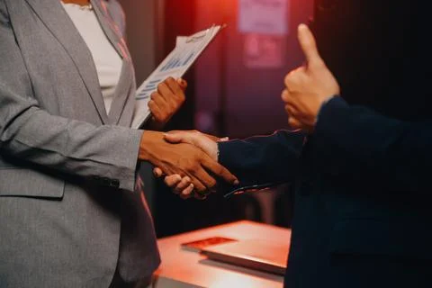 Team of software developers working on big project late at night in neon li.. 库存照片