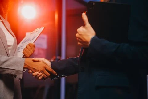 Team of software developers working on big project late at night in neon li.. 库存照片