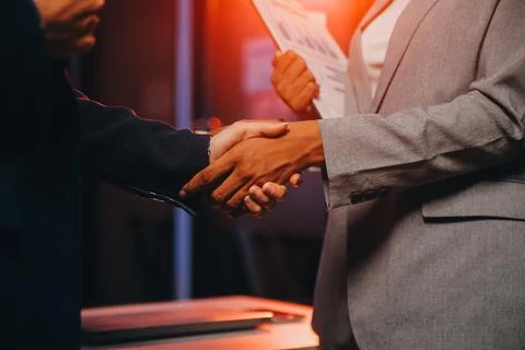 Team of software developers working on big project late at night in neon li.. 库存照片