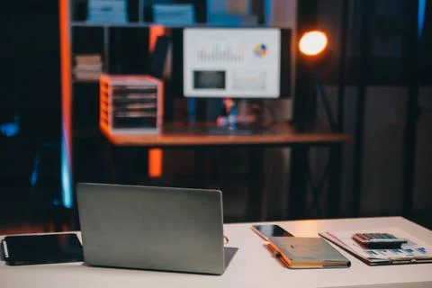 Team of software developers working on big project late at night in neon li.. 库存照片