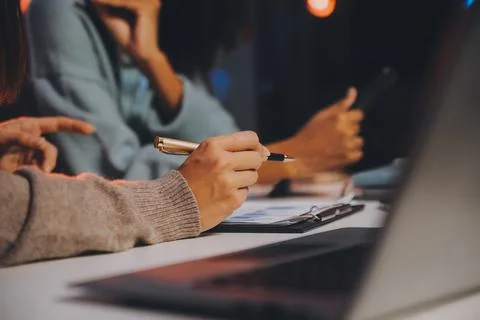 Team of software developers working on big project late at night in neon li.. 库存照片