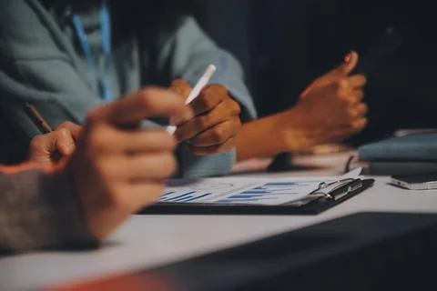 Team of software developers working on big project late at night in neon li.. 库存照片