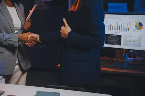 Team of software developers working on big project late at night in neon li.. 库存照片