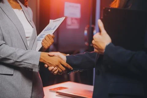 Team of software developers working on big project late at night in neon li.. 库存照片