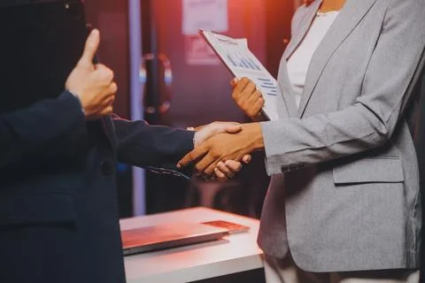 Team of software developers working on big project late at night in neon li.. 库存照片