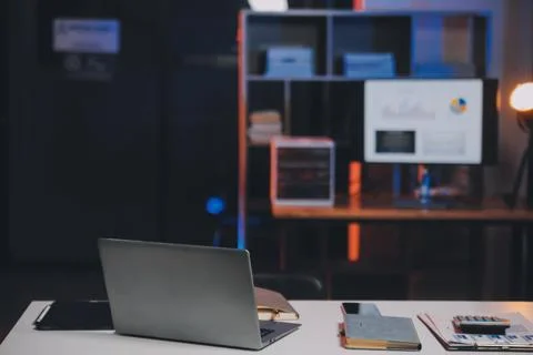 Team of software developers working on big project late at night in neon li.. 库存照片