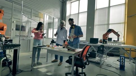 Team of software experts are observing bionic parts and talking Stock Footage 135584777