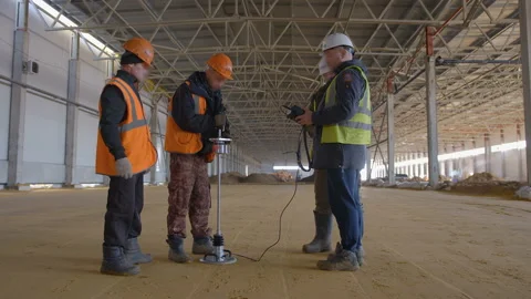 A team of specialists using the dynamic soil density meter check  Stock Footage 162017190