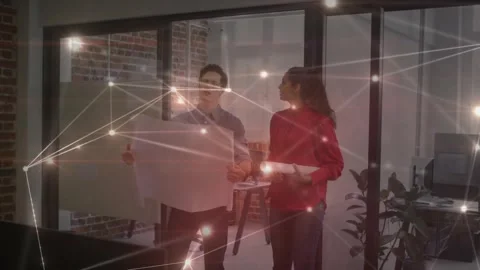 Team spreading plan and pointing by glass wall while node grid highlighting Video stock 330768072