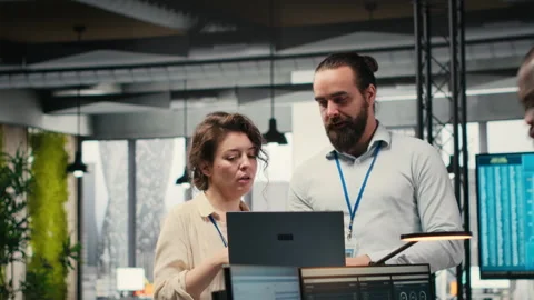 Team of staff members work with high tech and performance metrics 스톡 동영상 313962967