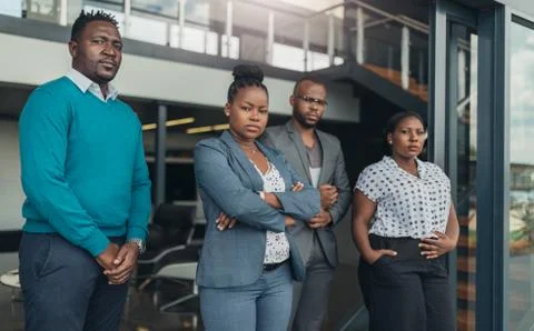 Team of standing confident black business people crossing arms  Stock Photos