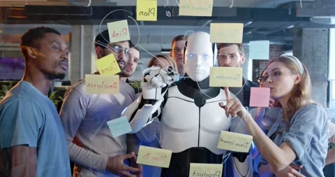 Team of startup planning future tasks in office with humanoid. People and Stock Footage 180042361